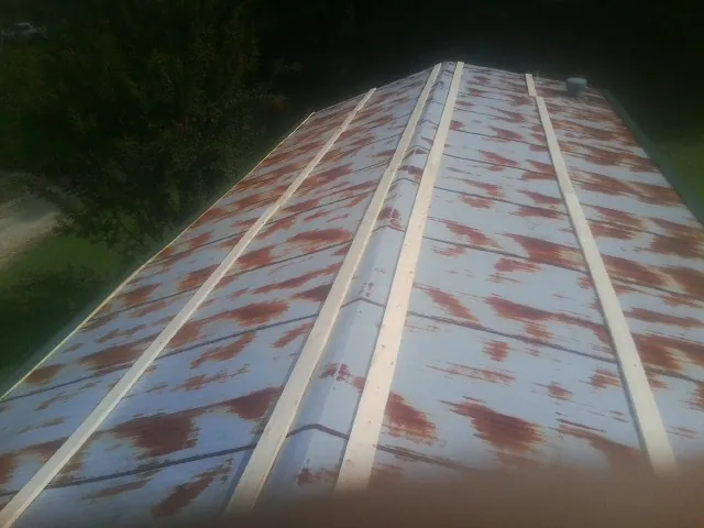 Rusted metal roof panels with new wood purlins before replacement — Storm Damage Roof Repair in Belleview by Roofing Brothers